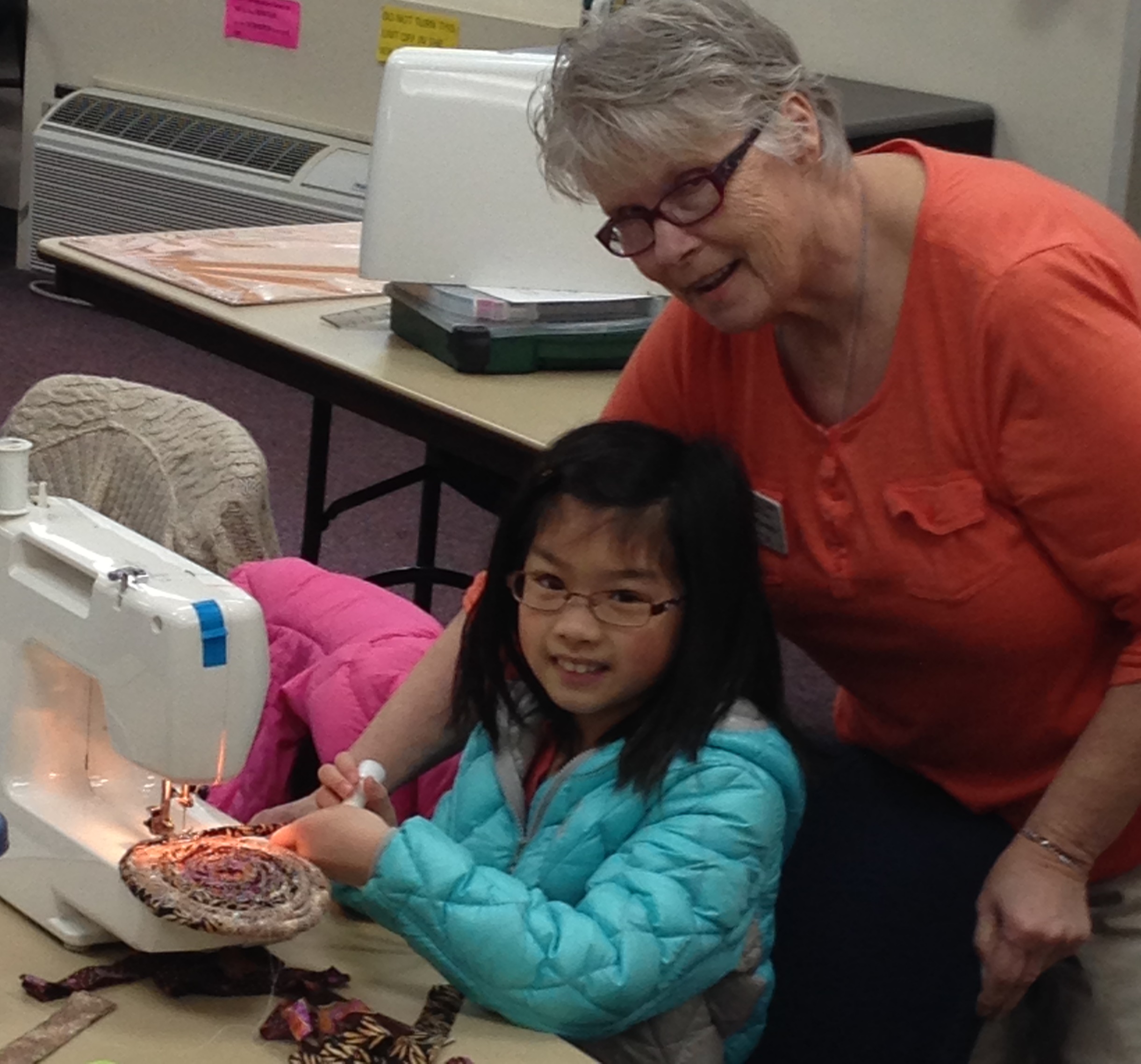 Adult woman sewing with child
