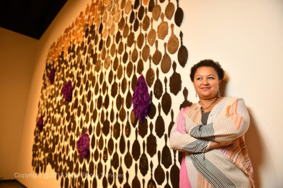 Io standing in front of her work