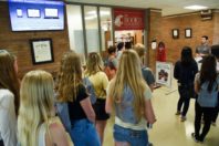 Students gathered in a hallway during a campus tour.