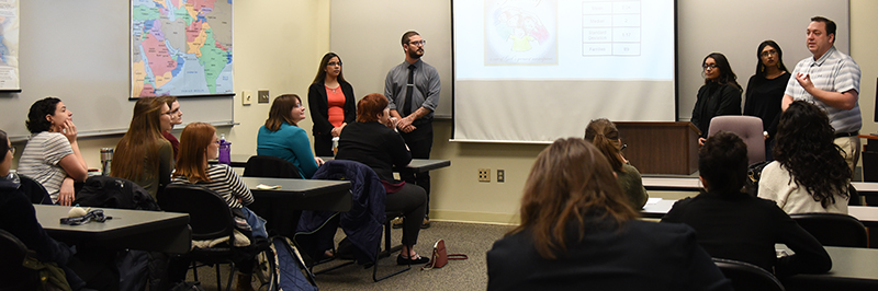 Students presenting in a classroom.