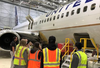 Murray at a United Airlines San Francisco facility with data analytics seniors