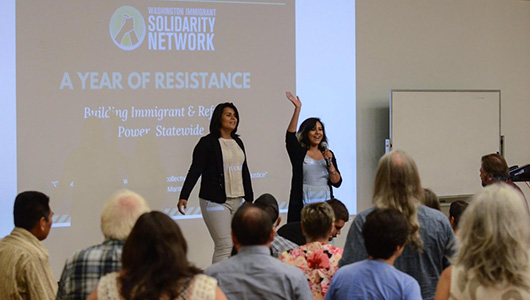 Brenda Rodriguez and colleague Monserrat Padilla speaking to an audience.