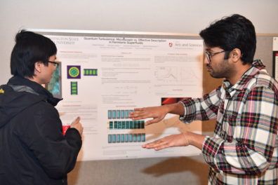 A researcher explaining a scientific poster.