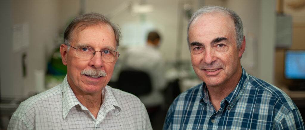 portrait of two older men, side by side.