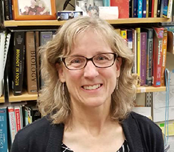 Lisa Carloye in front of biology books.