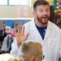 WSU Everett engineering student Brandon Clark describes a bridge-building activity to young students