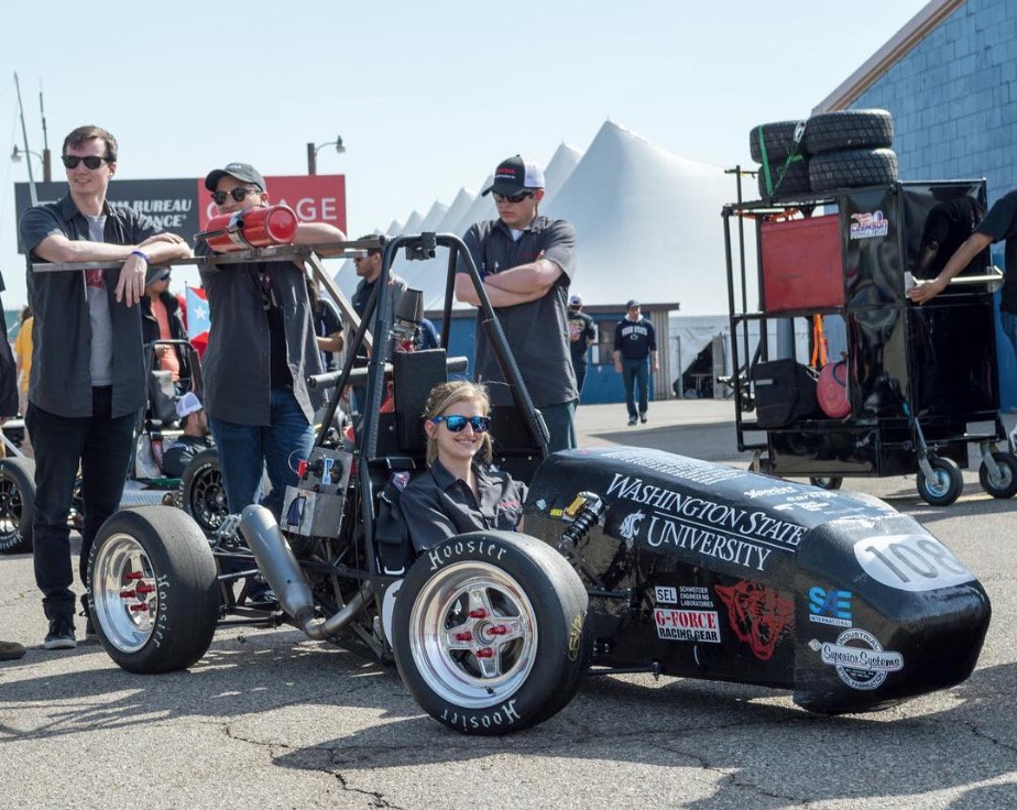 Heidi Lyons sitting in the WAZZU Racing car.