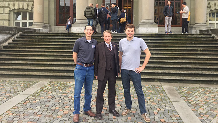 Andrew Porter, Joseph Iannelli, and Florian Baertsch standing in front of the entrance to ZHAW.