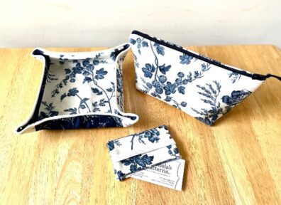 A folding travel tray, wallet holder, and cosmetic bag