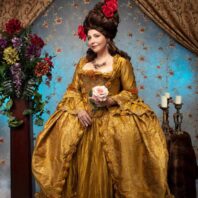 A woman in an ornate historical costume.