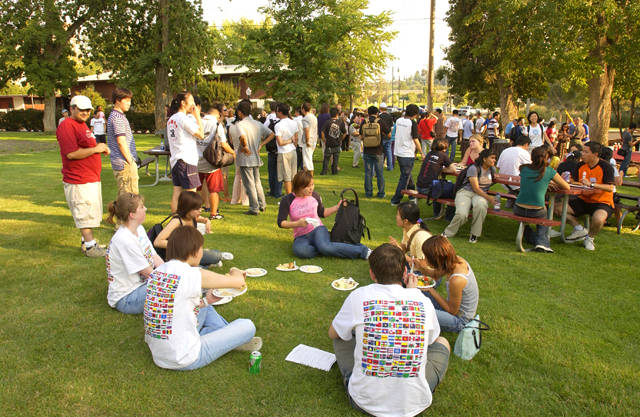 Image of students sitting in a circle at the International Student Picnic at Reaney Park