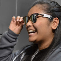 Student tries on sunglasses