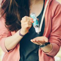 student using hand sanitizer