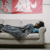 student laying on couch