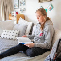 student in room studying book