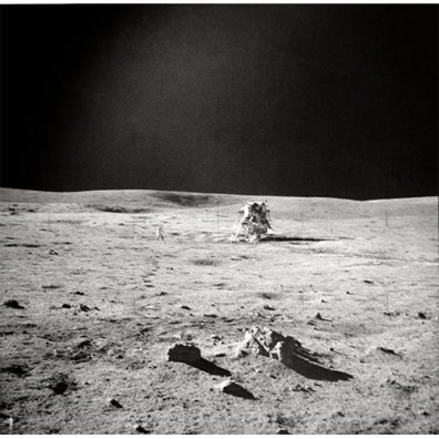 a photograph of an astronaut crouching on the moon's surface