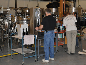 Technicians at the WSU research winery in Prosser bottling wine made from grapes grown on scion's grown on rootstocks commonly used in commercial-scale vineyards. Photo: Washington State University; higher resolution versions available upon request.