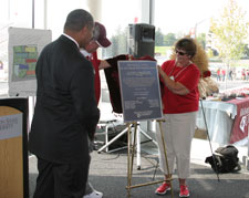 While Washington State University President Elson S. Floyd looks on, Dick Vogel, Orville A. Vogel's son, and Dick's wife Pat, unveil a replica of a plaque that will be displayed in the main entrance of the Orville