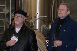 thk-tour Keith Thurman (left) and viticulture and enology program director Thomas Henick-Kling listen to the winemaker of Tsillan Cellars Winery and Vineyards explain the challenges of selling wine in Washington. Photo by Bob Hoffmann/WSU.