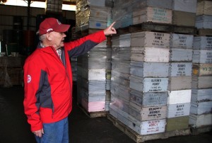 Eric Olson with pallets of empty hive boxes. Photo by Darrell Kilgore, WSU.
