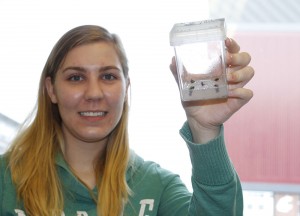 Sonia Weatherly, an undergraduate researcher in Dhingra’s Genomics and Biotechnology laboratory holds a container of ex-plants, cuttings from apples on Steptoe Butte. Researchers hope to create new grafts and eventually, new heirloom apple trees, from samples like these. Seth Truscott/CAHNRS photo