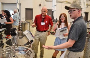 Associate Professor of Enology Jim Harbertson shows new equipment to visitors at the new Ste. Michelle Wine Estates WSU Wine Science Center.