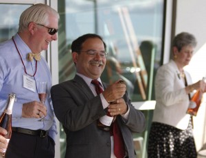 Provost Dan Bernardo, center, pops a celebratory cork with WSU Regent Mike Worthy. At right is Regent Lura Powell.