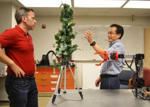 Changki Mo, right, talks with doctoral student Joseph Davidson about the physical design of an apple-picking robot. (Photo by Maegan Murray, WSU Tri-Cities)