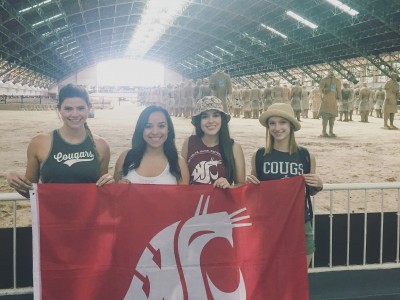 Alison DePhillips, Graciela Vela, Yeseily Pruneda, and Kaitlyn Jo Engle hold the WSu banner at the ancient Terracotta Warriors site in Xi'an.