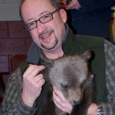 Heiko Jansen holding a bear cub.