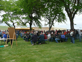 Kennedy4e A crowd listening to a presentation at Lind Field Day.