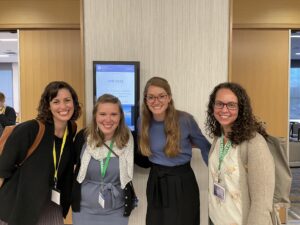 Four people smiling.