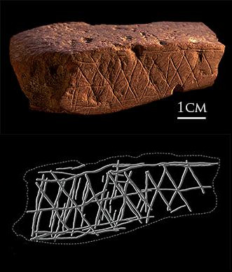 A reddish stone showing regular knife markings