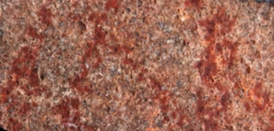 A photo of a red rock with red painting on it