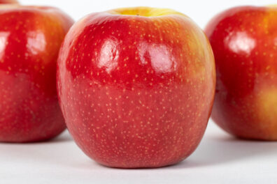Three red apples with white-ish speckles