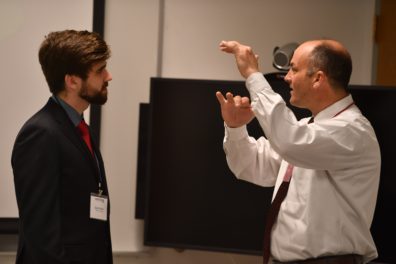 student talking to competition judge