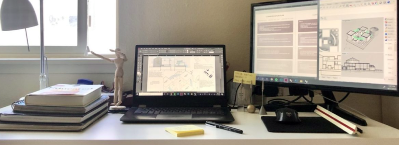 Computer screen showing design drawings and student desk with books.