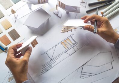 Person building an architecture model. 