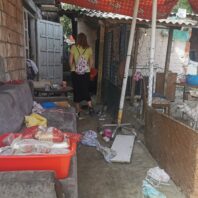 woman walking toward door, away from camera