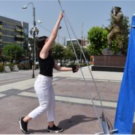 young woman standing up a sign holder