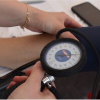 hands holding a blood pressure cuss