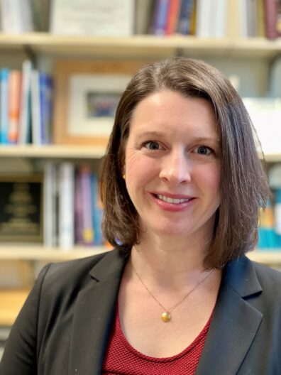 Jessica Willoughby standing in front of bookshelf