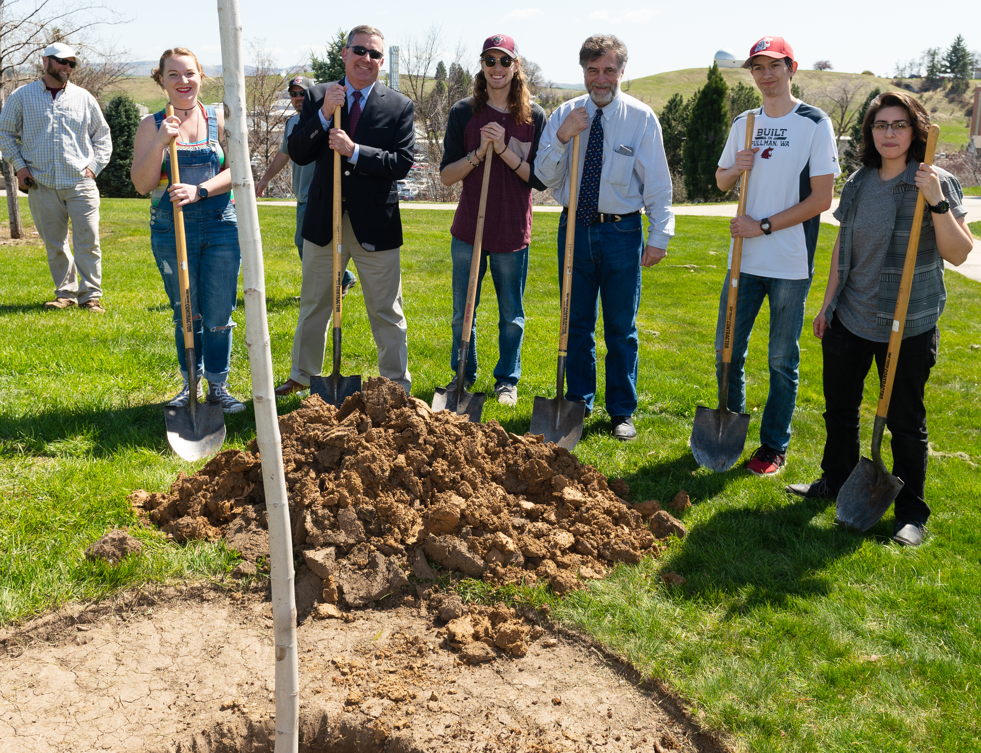 Members of the Washington State University Horticulture Club and President Kirk Schulz holding shovels after planting a Red Maple tree.
