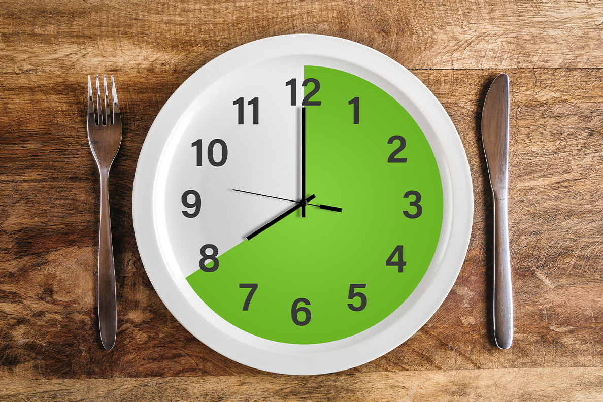A place setting with a dinner plate that resembles a clock.