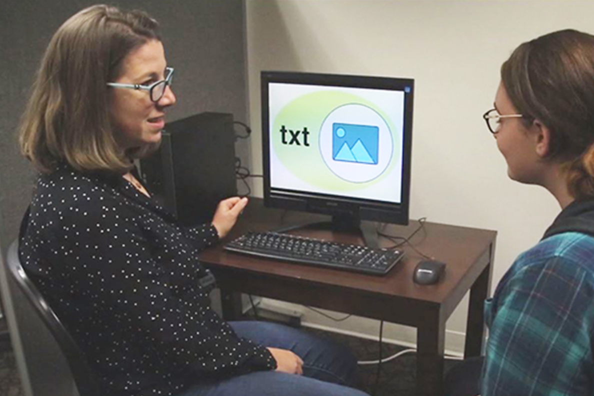 Kira Carbonneau (left) has a conversation with a student.