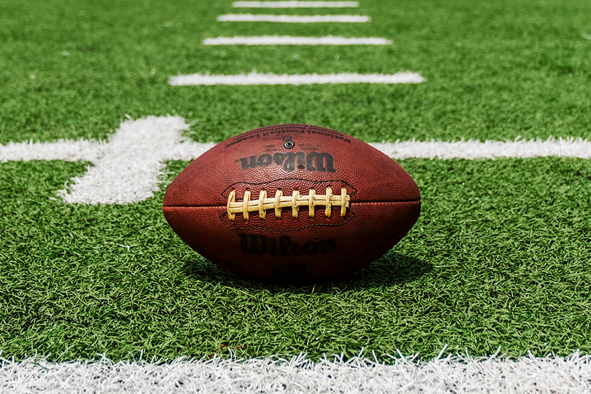 An American football set on an empty field.