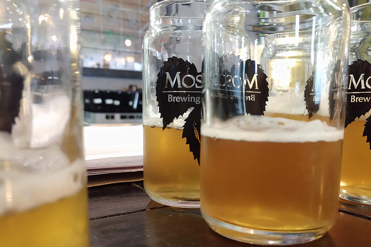 Four jars of beer with slightly different hues.