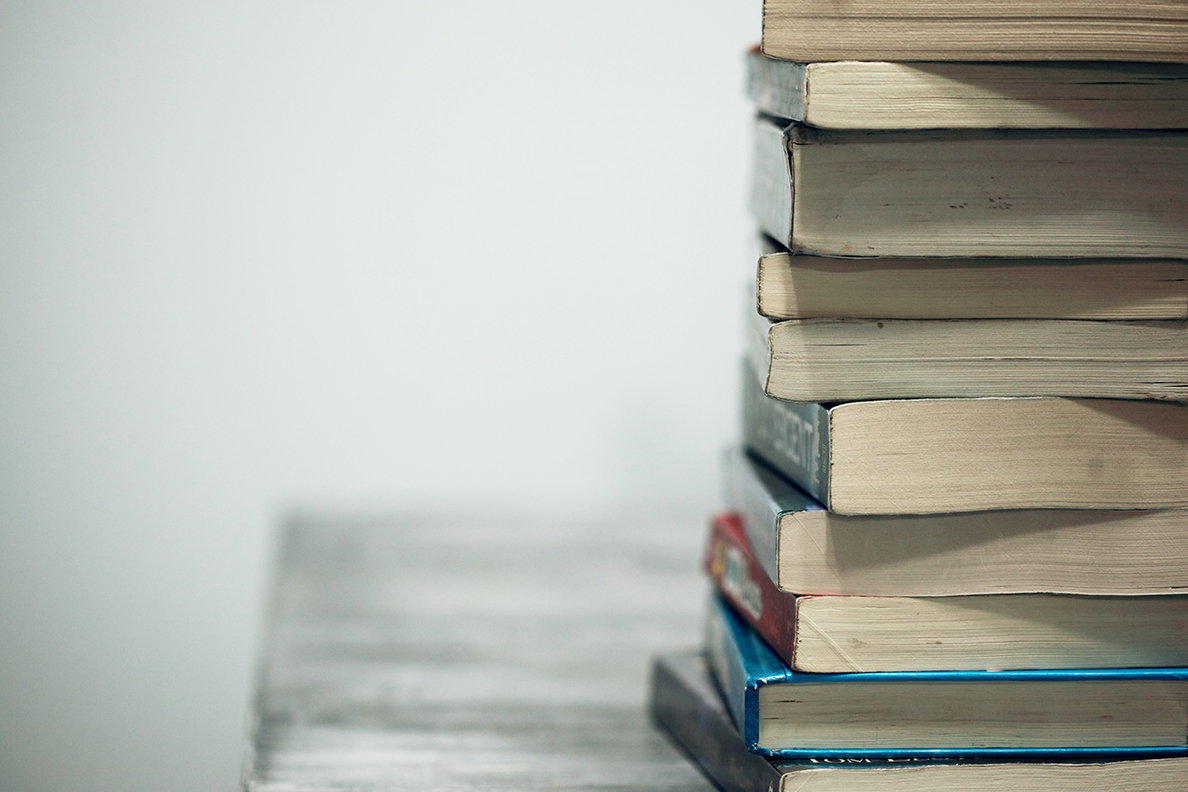 Stack of books on an empty table.