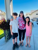 A WSU Global Campus student posing with two children.