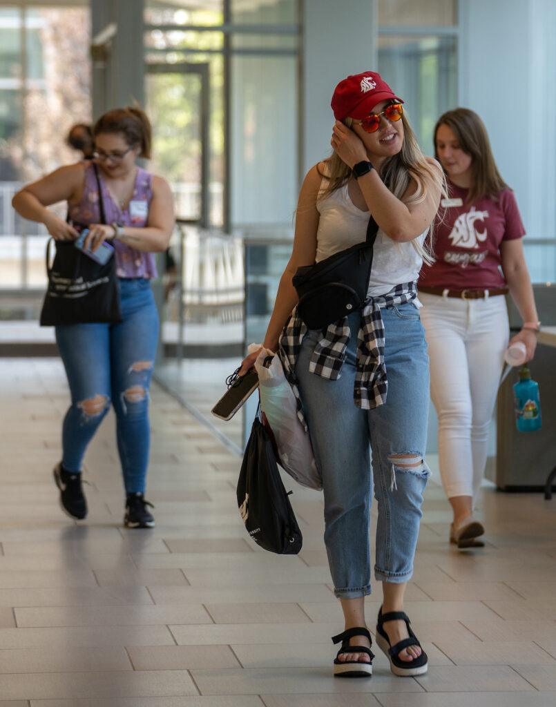 WSU Spokane students walking down a hallway.